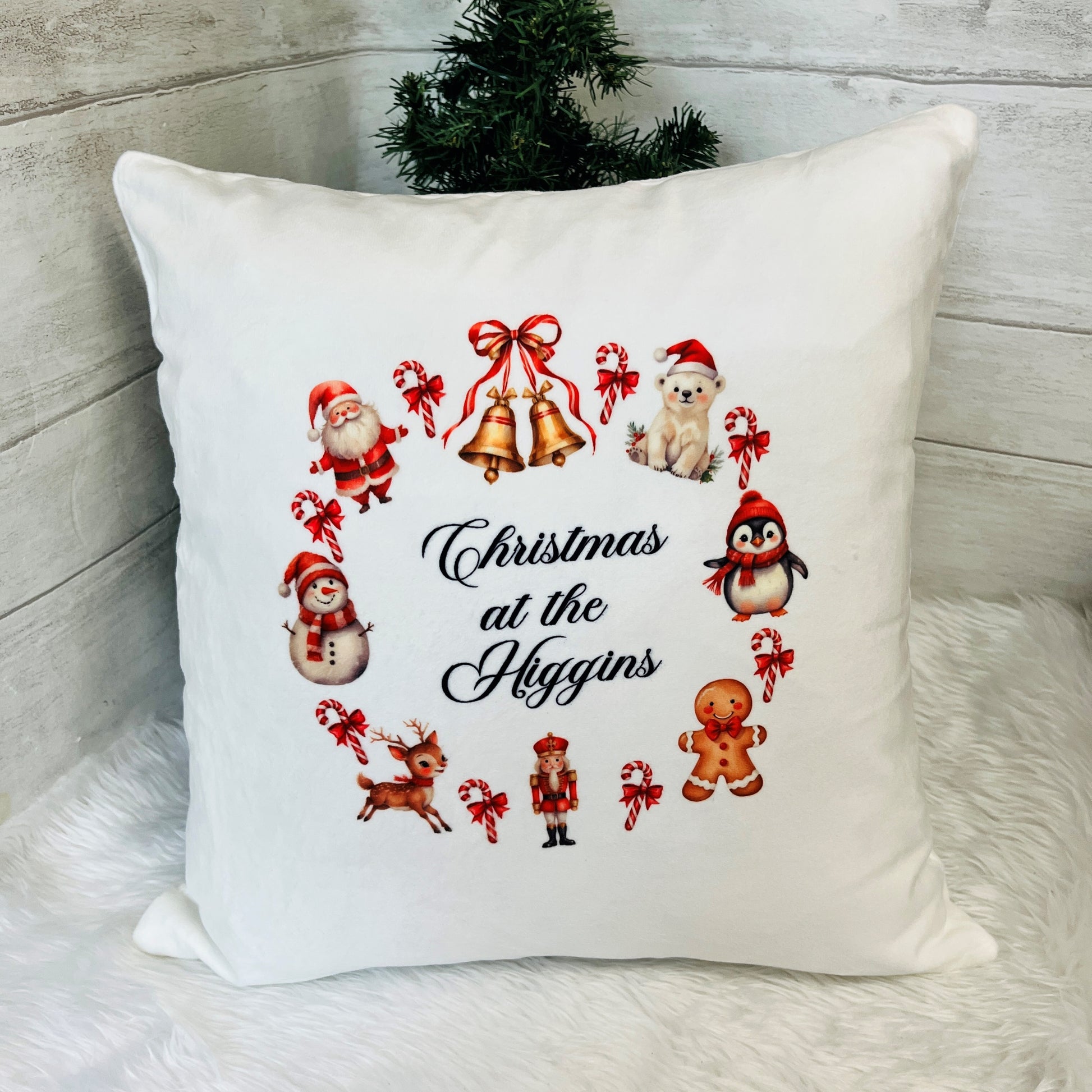 Decorative pillow with Christmas-themed illustrations and 'Christmas at the Higgins' text.