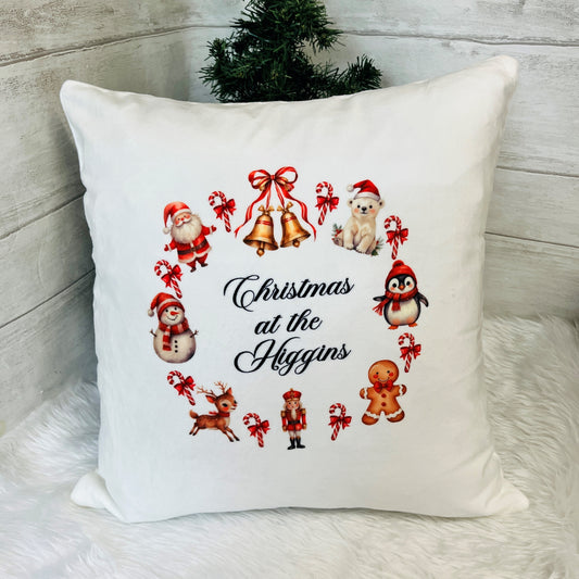 Decorative pillow with Christmas-themed illustrations and 'Christmas at the Higgins' text.