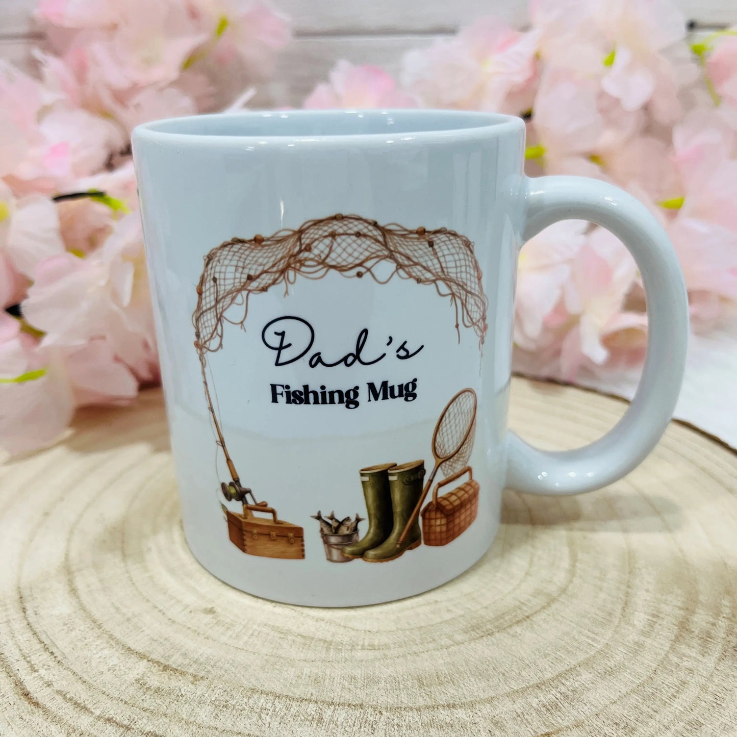 White mug with 'Dad's Fishing Mug' design on a wooden surface