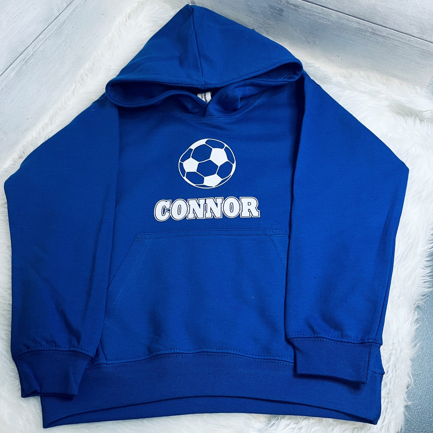 Blue hoodie with football design and 'CONNOR' text in white