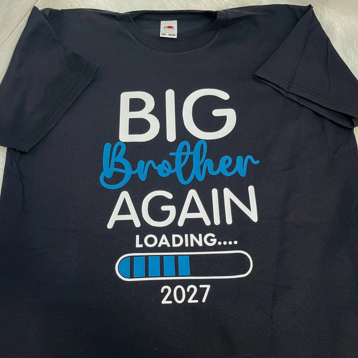 A navy blue short-sleeve t-shirt laid flat, featuring a graphic print that reads 'BIG Brother AGAIN LOADING.