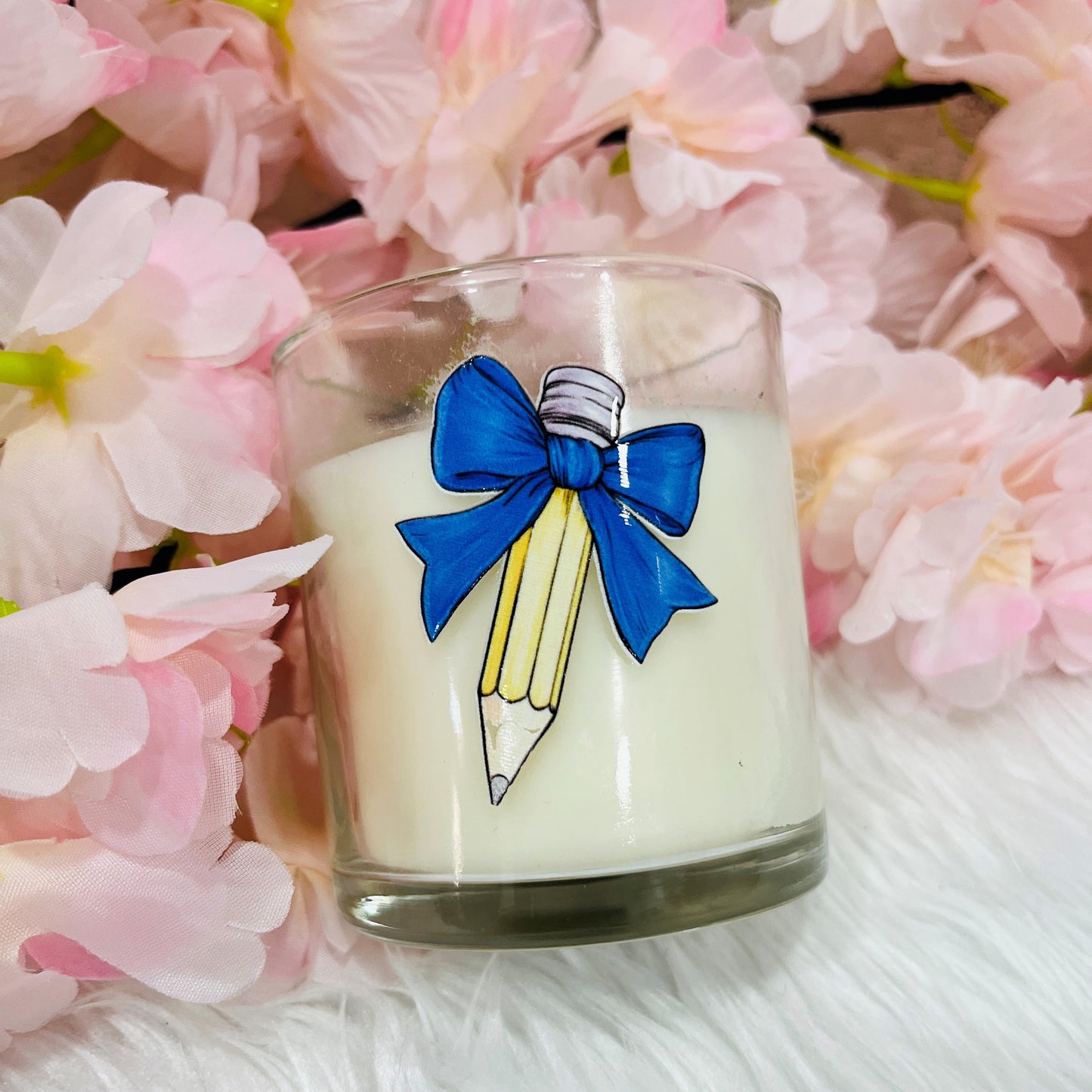 A Teachers candle with a bow design in Navy Blue on the front