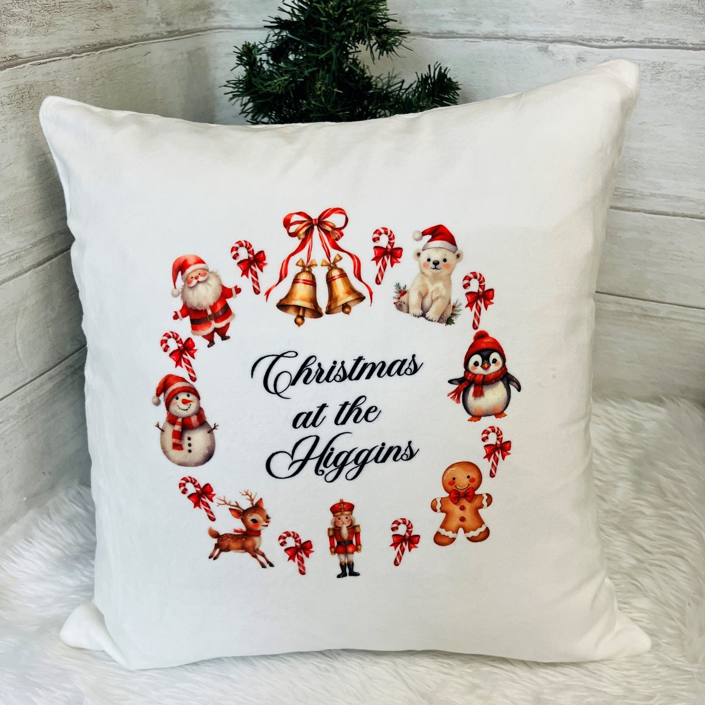 Decorative pillow with Christmas-themed illustrations and 'Christmas at the Higgins' text.