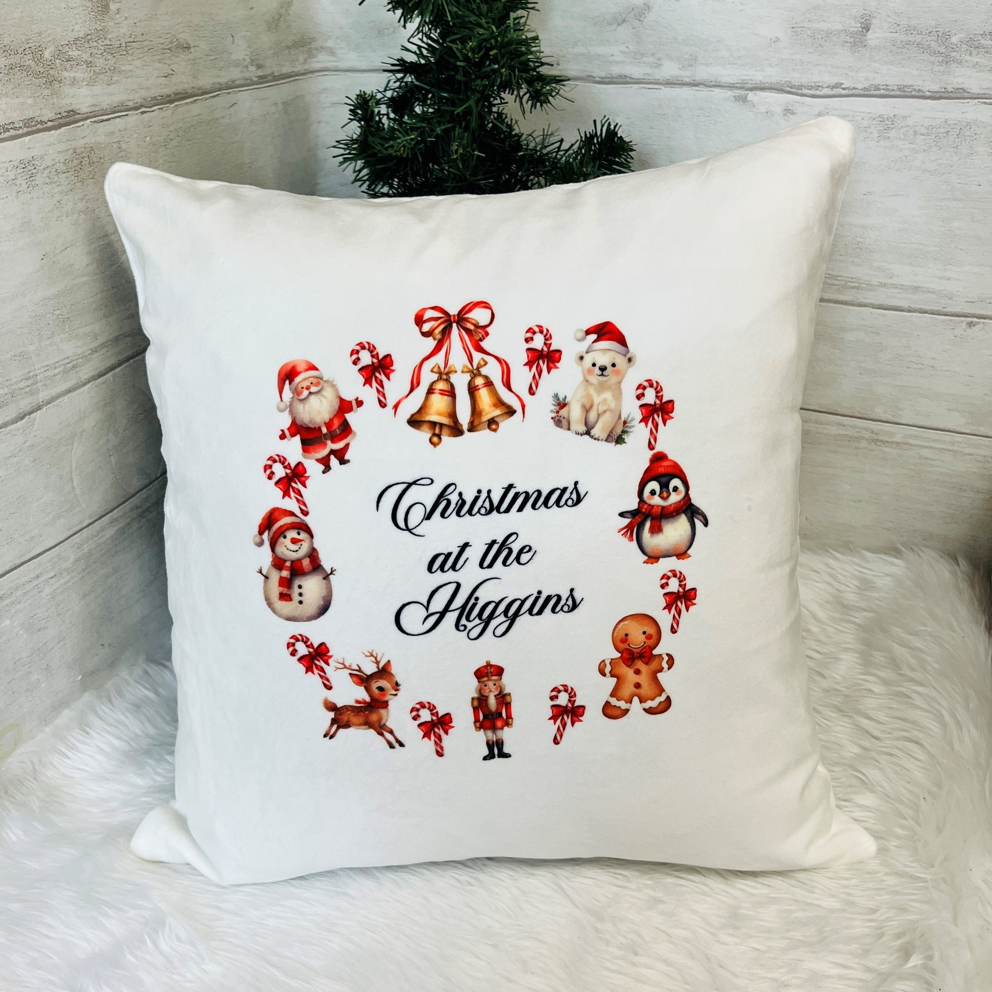 Decorative pillow with Christmas-themed illustrations and 'Christmas at the Higgins' text