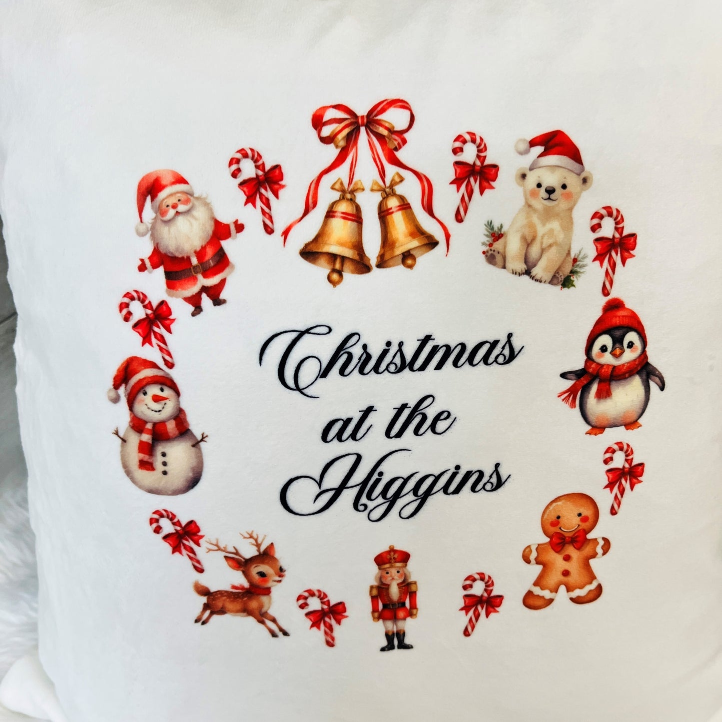 Decorative pillow with Christmas-themed illustrations and 'Christmas at the Higgins' text.