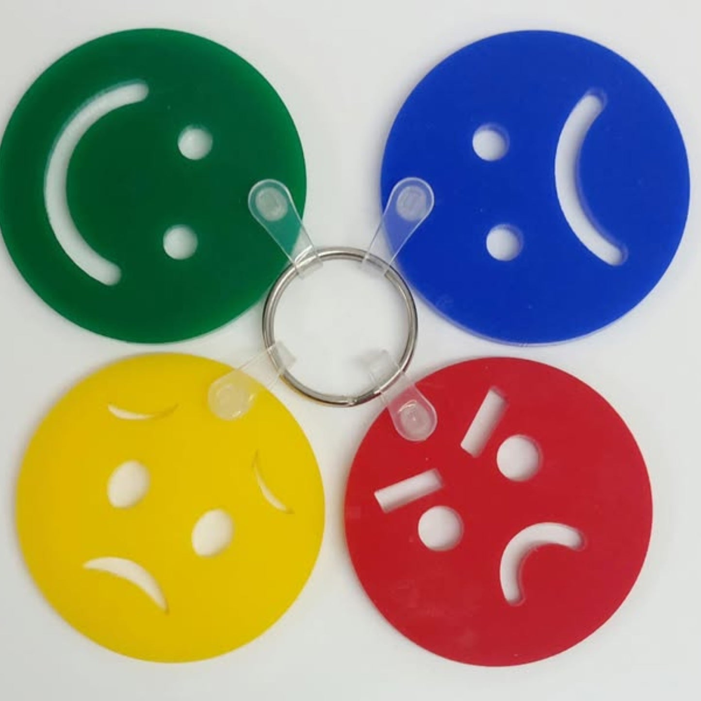 An image of 4 coloured discs with different facial expressions to express one's mood and feelings