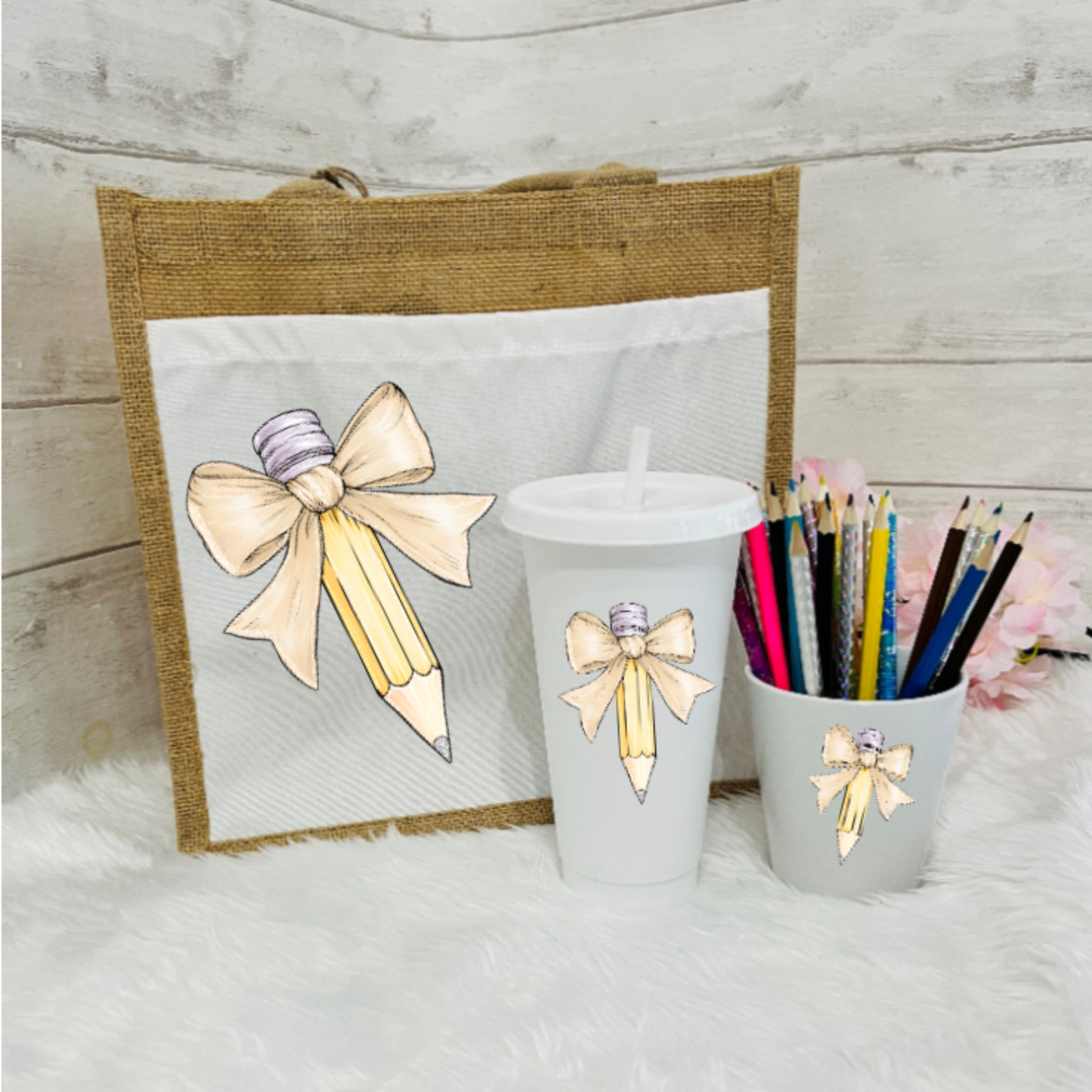 A set of personalized teacher's gifts including a jute bag with a bow and pencil design, a white cold cup with a bow and a pencil pot with beige bow design.