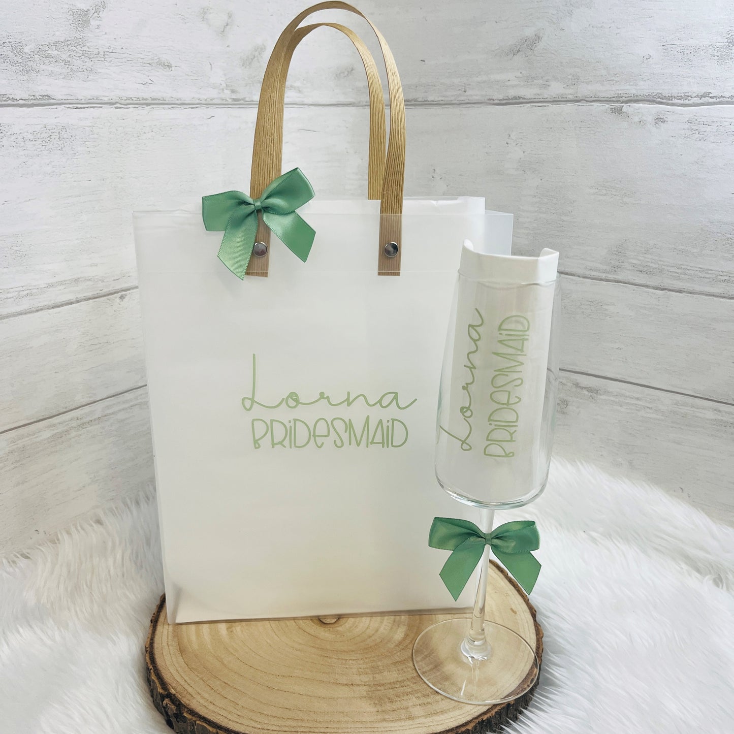 Frosted Gift bag with 'Lorna Bridesmaid' text and a matching champagne flute on a wooden surface.
