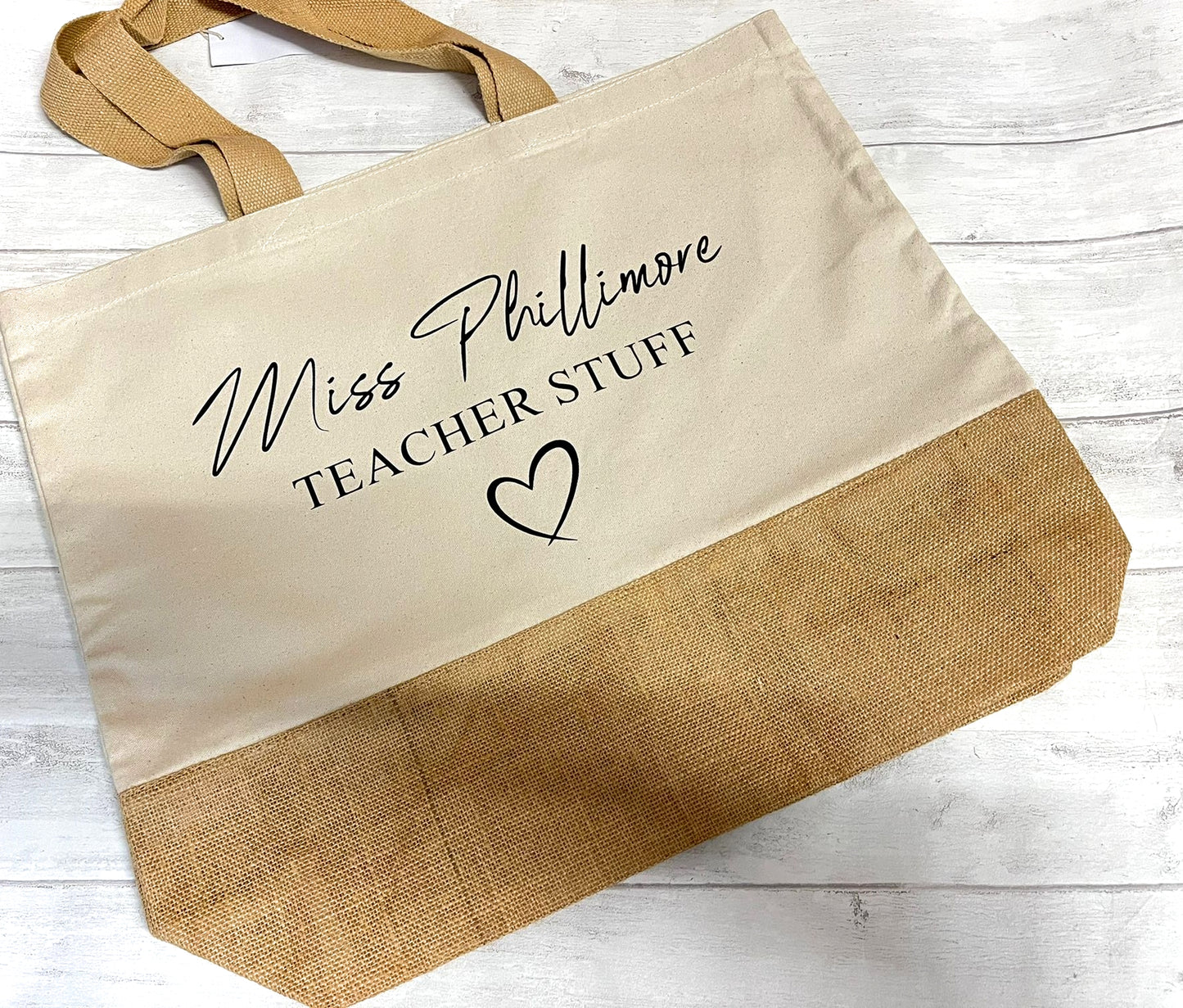Tote bag with 'Miss Phillimore Teacher Stuff' text on a wooden surface