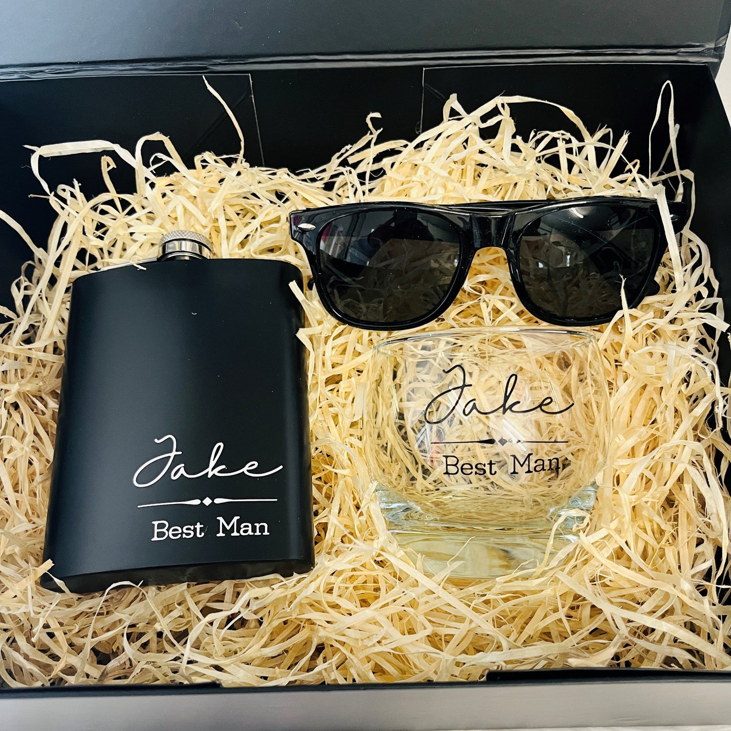 Gift set with black flask, glass, and sunglasses labeled 'Jake Best Man'