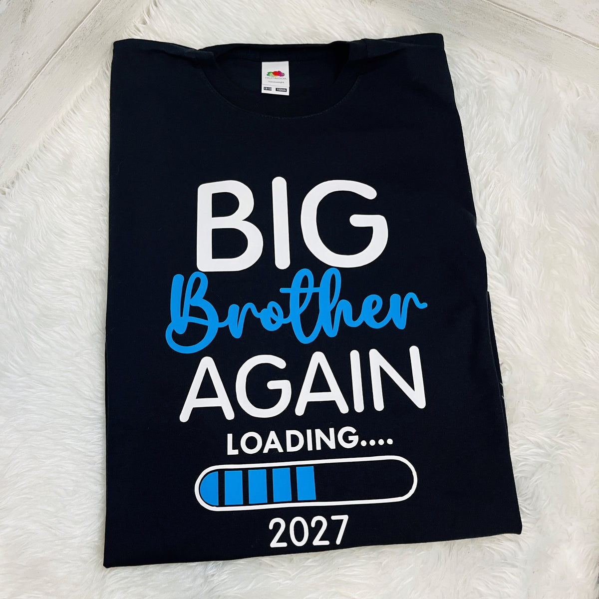 A folded Navy t-shirt with a graphic print reading 'BIG Brother AGAIN LOADING.