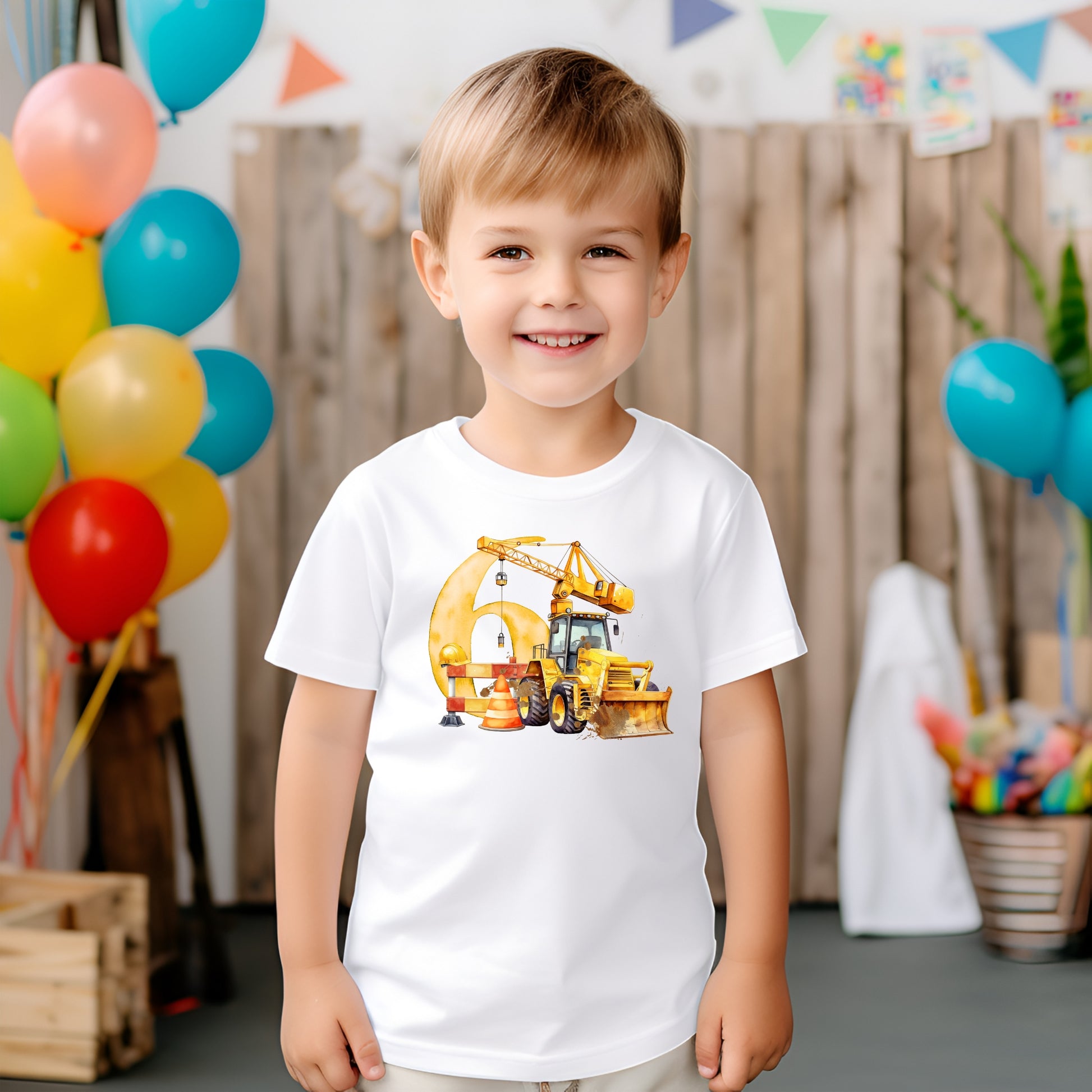 A child wearing a white 
T-shirt with a digger image and the number 6 on the front 