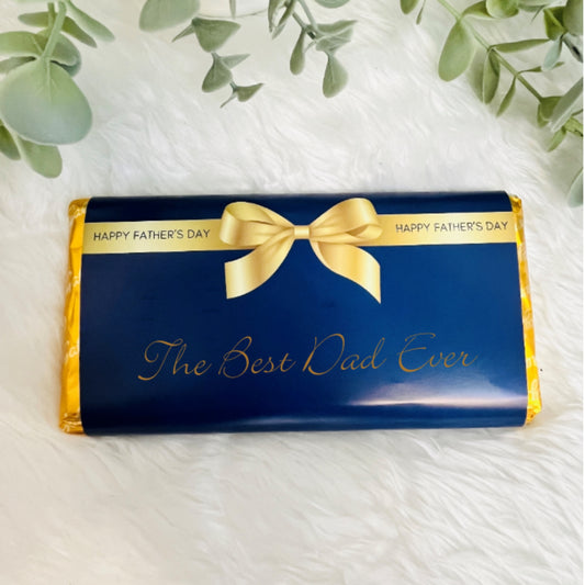 A navy and gold chocolate wrapper for fathers day with the text 'from your favourite child'