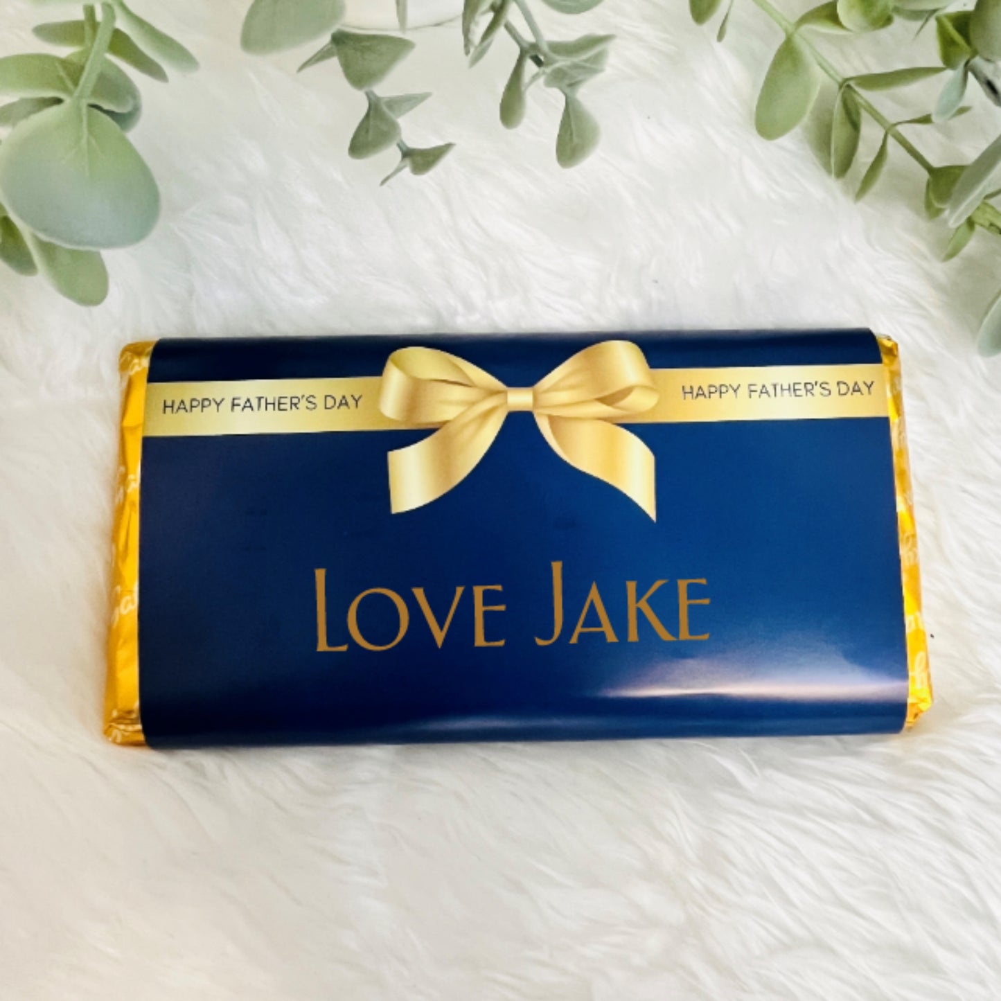 A navy and gold chocolate wrapper for fathers day with the text 'from your favourite child'