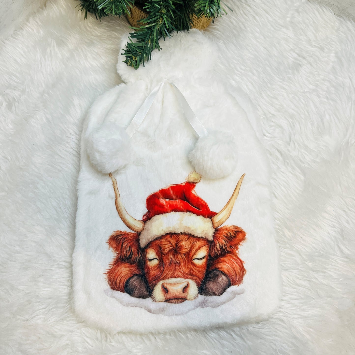 Highland cow wearing a Santa hat on a Plush Hot Water Bottle