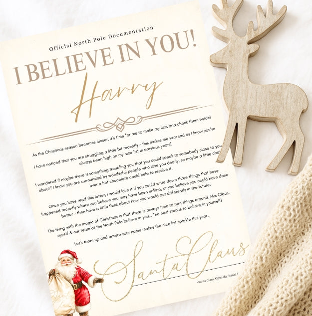Believe in you Letter from Santa Claus with a wooden reindeer toy on a textured surface