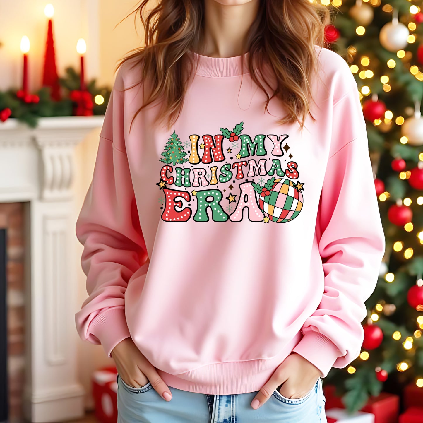 A lady wearing a pink jumper with 'In my Christmas Era' on the front in a colourful design