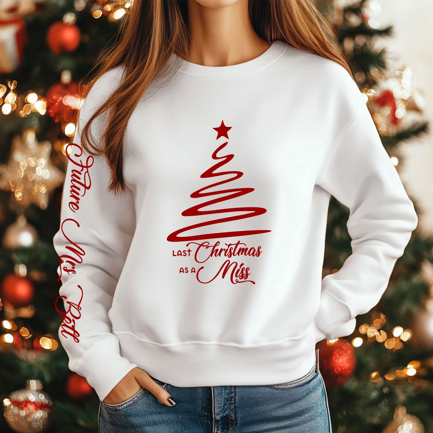 Woman wearing a white jumper with the design of 'last christmas as a miss' on the front and the 'future mrs' on the sleeve