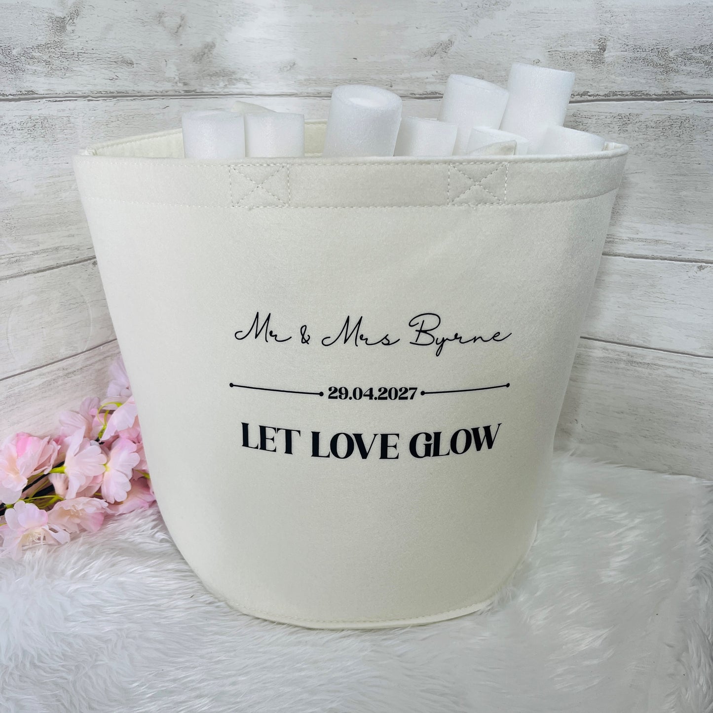 Cream Felt Bag with personalized wedding text  on a white surface