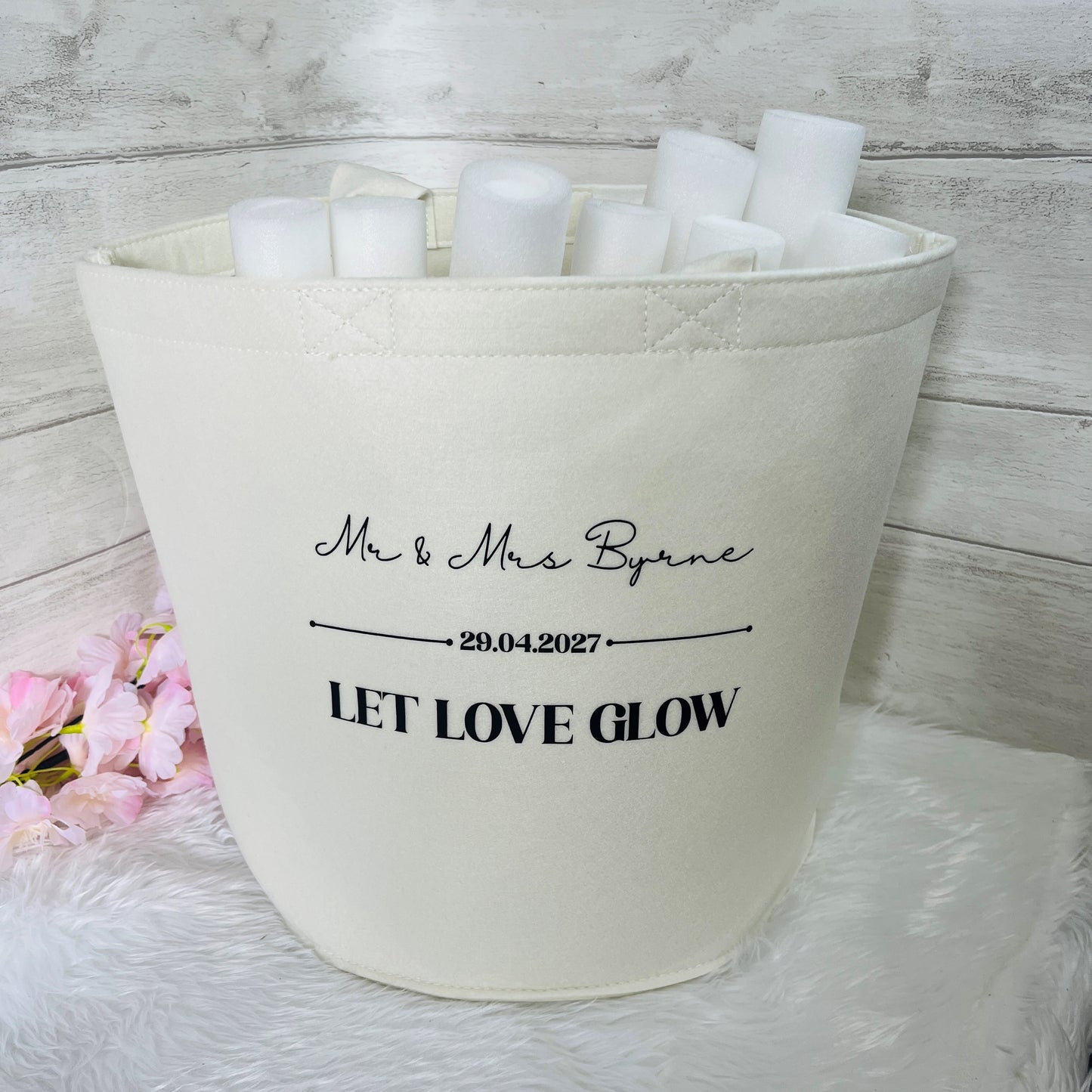 Cream Felt bag with personalized text and personalised glow sticks on a white background