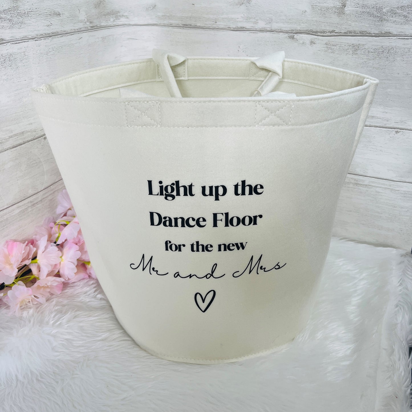 White felt trug with text 'Light up the Dance Floor for the new Mr and Mrs' on a light wooden background.