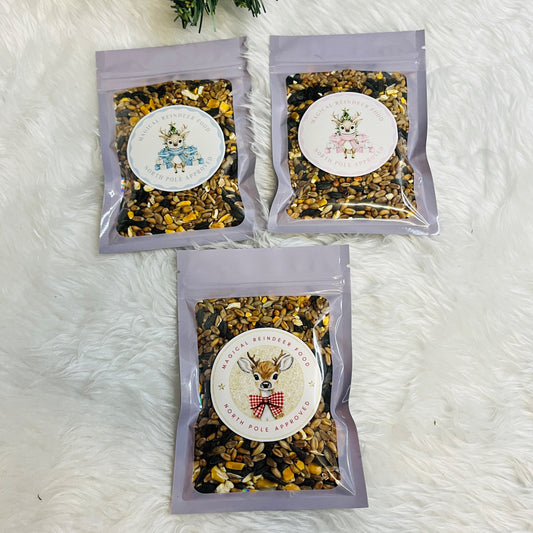 Three packets of reindeer food  in a clear sealed envelope with a pink, blue or red sticker