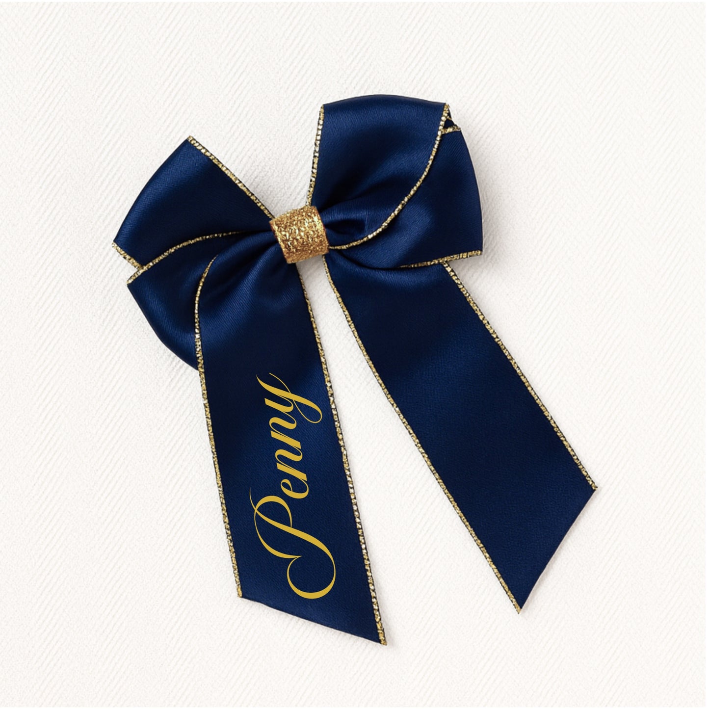 Navy blue bow with gold trim and 'Penny' text on a white background