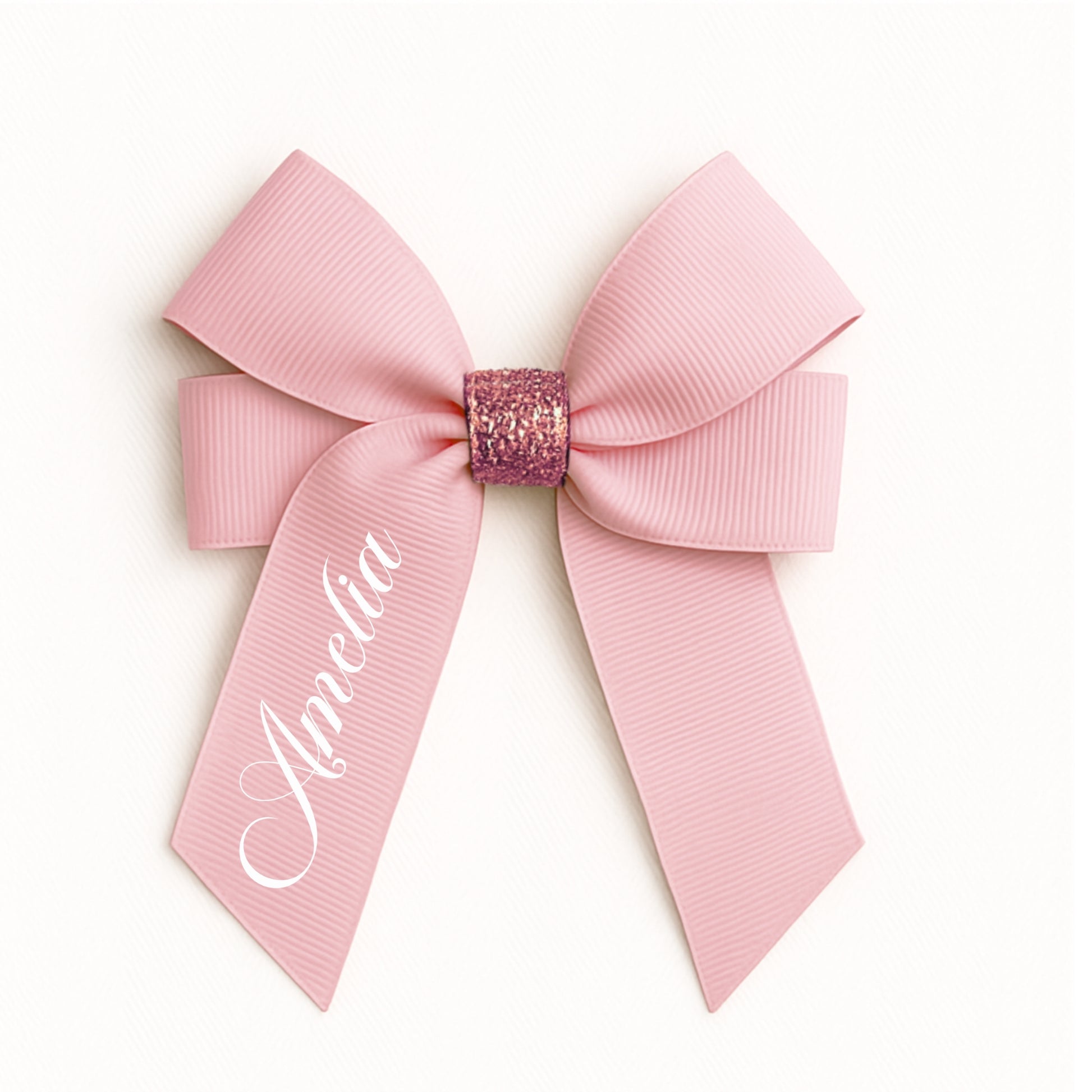 Pink bow with glittery center and 'Amelia' text on a white background