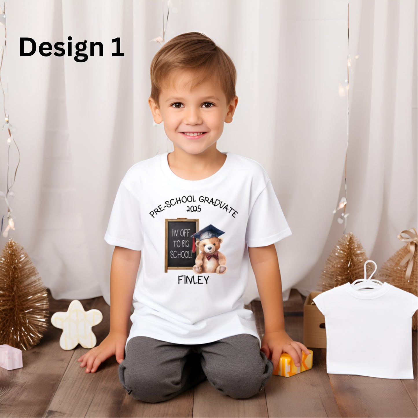 Boy wearing a white t-shirt with 'pre school graduate' design