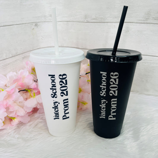 Two tumblers with 'Yateley School Prom 2026' text on a white surface with pink flowers.