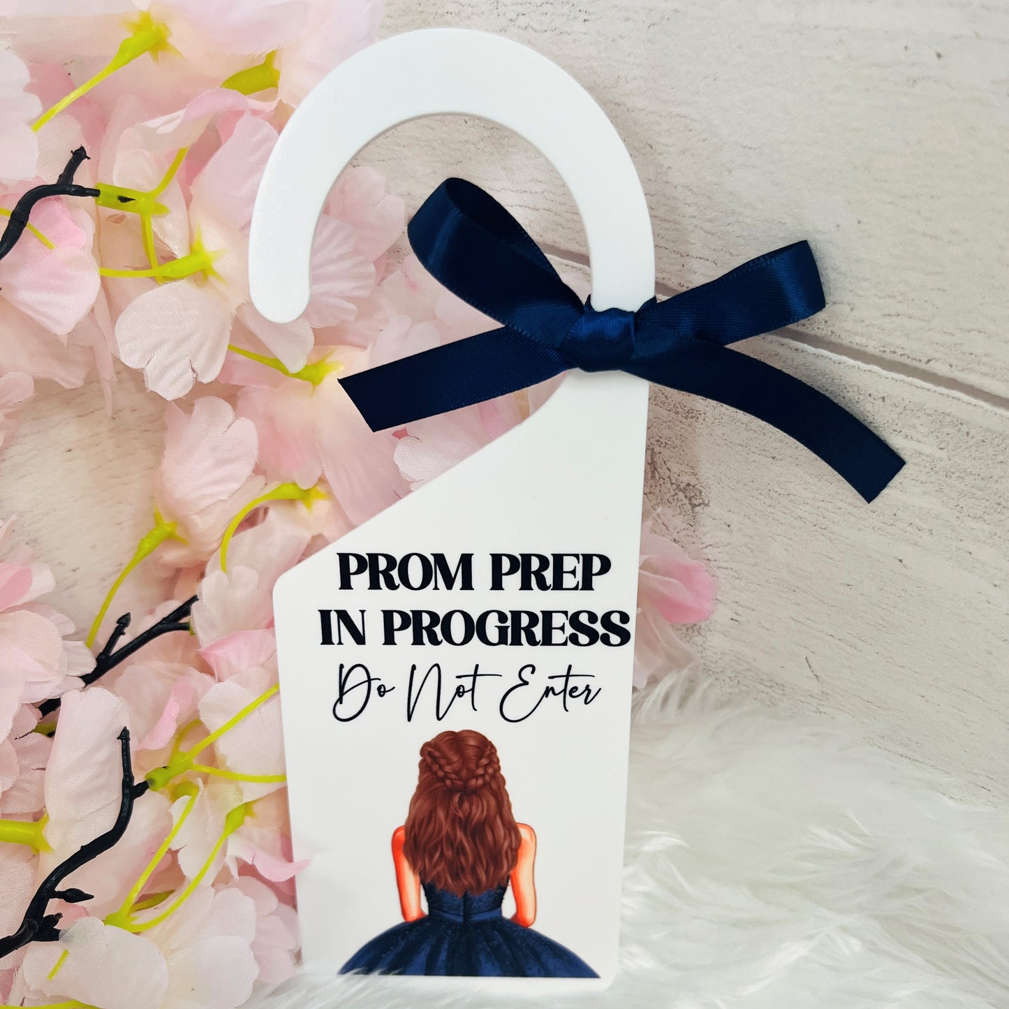 White acrylic door hanger with a design of a navy prom dress and co-ordinating bow with the text 'Prom prep in progress do not enter'