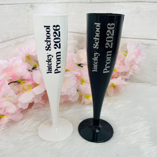 Two personalized champagne flutes with 'Yateley School Prom 2026' text on a white background with pink flowers.