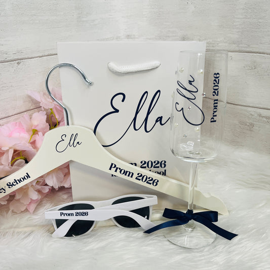 A collection of personalised Prom items including a gift bag, hanger, glass and sunglasses on a white background