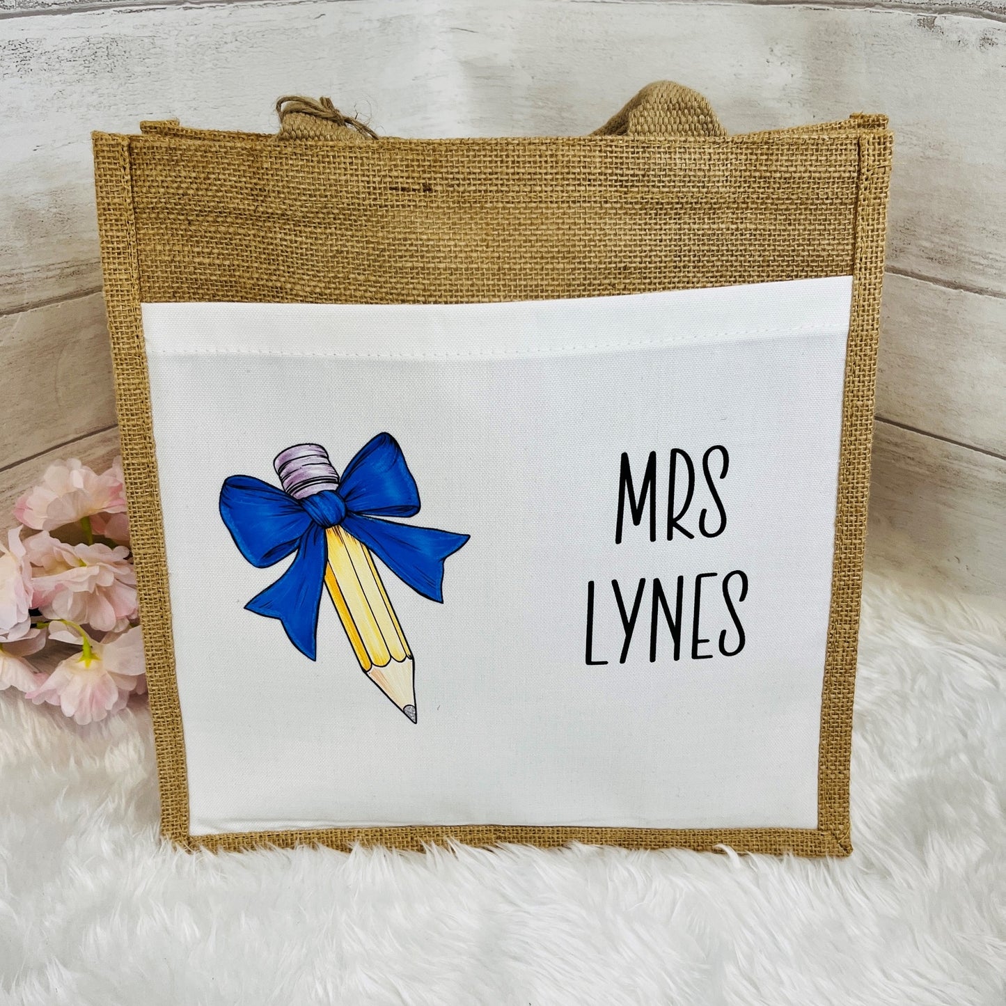 Jute bag with a pencil and bow design and 'Mrs Lynes' text on a white background.