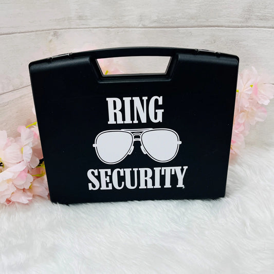Black box with 'Ring Security' text and sunglasses graphic on a light background