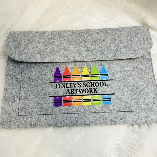 Grey felt envelope folder with colorful crayon design and 'Finley's School Artwork' text on a white background