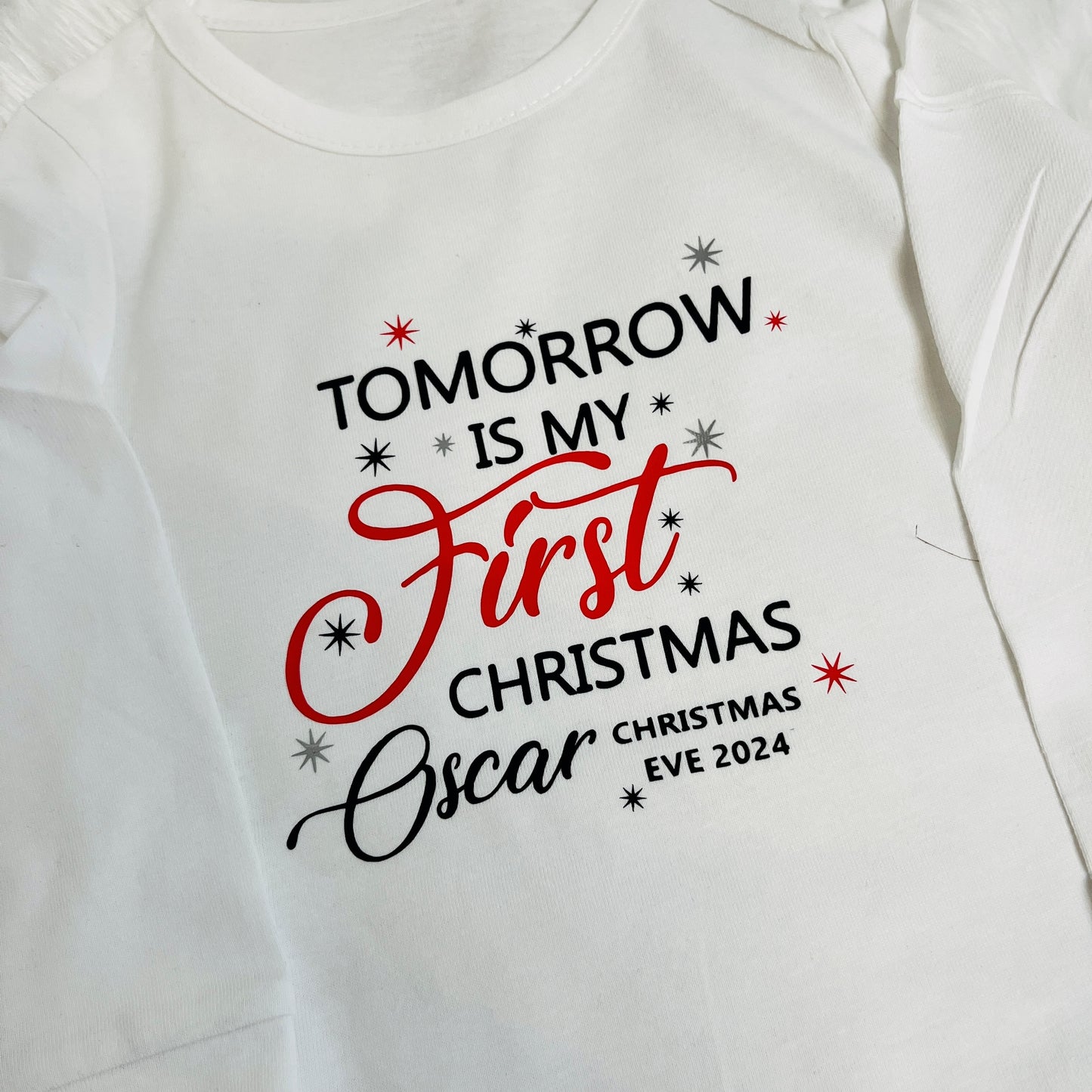 White sleepsuit with 'Tomorrow is my first Christmas Eve 2024