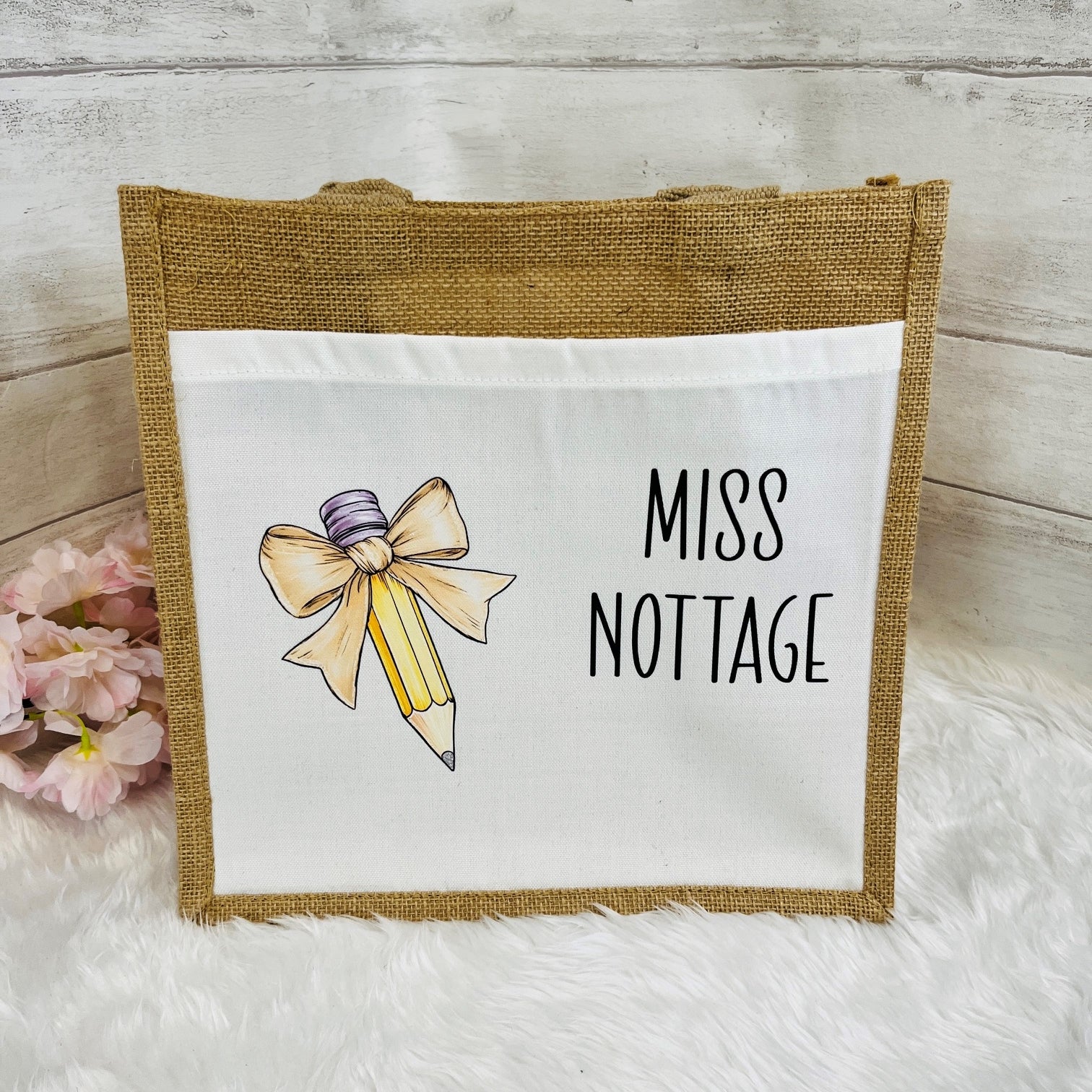 Tote bag with 'Miss Nottage' design featuring a bow and pencil on a white background.
