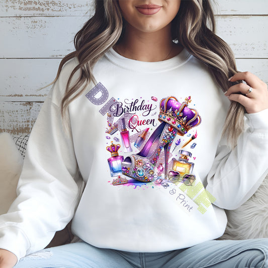 Person wearing a white sweatshirt with a colorful 'Birthday Queen' design.