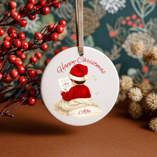 Personalized Christmas ornament with a child in a Santa hat and red sweater, surrounded by festive decorations.