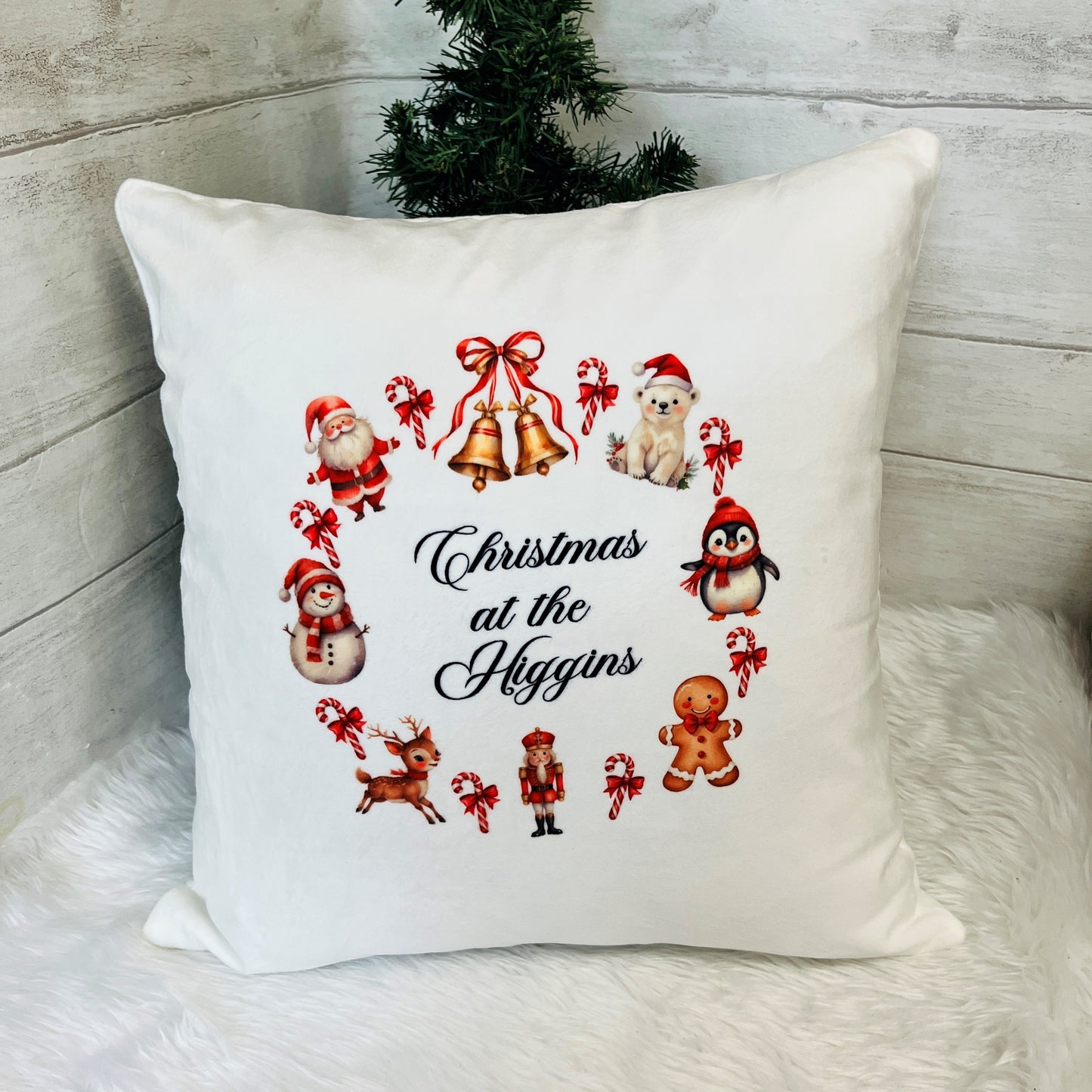 Decorative pillow with Christmas-themed illustrations and 'Christmas at the Higgins' text 