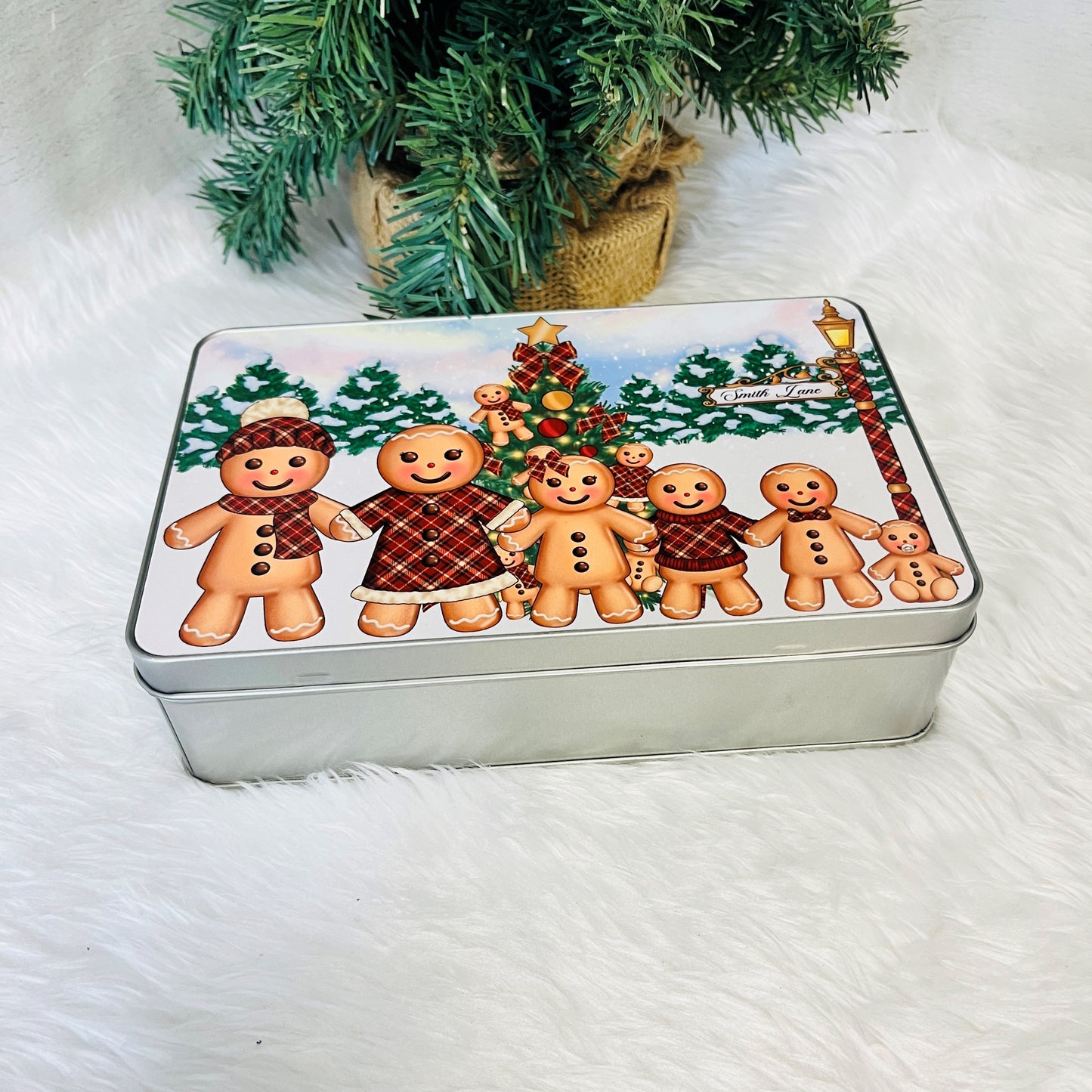 Metal tin with gingerbread design on a white surface 