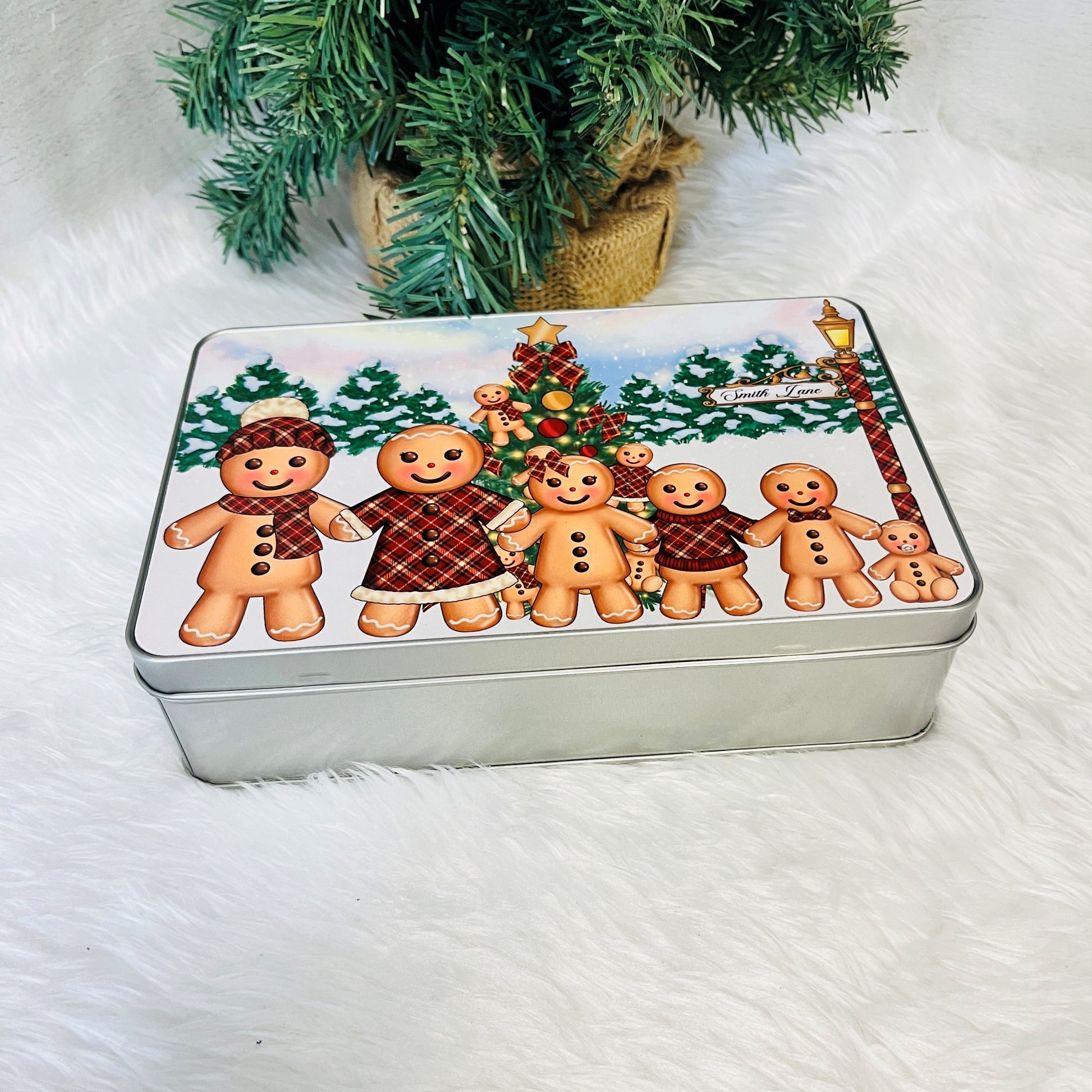 Metal tin with gingerbread design on a white surface 
