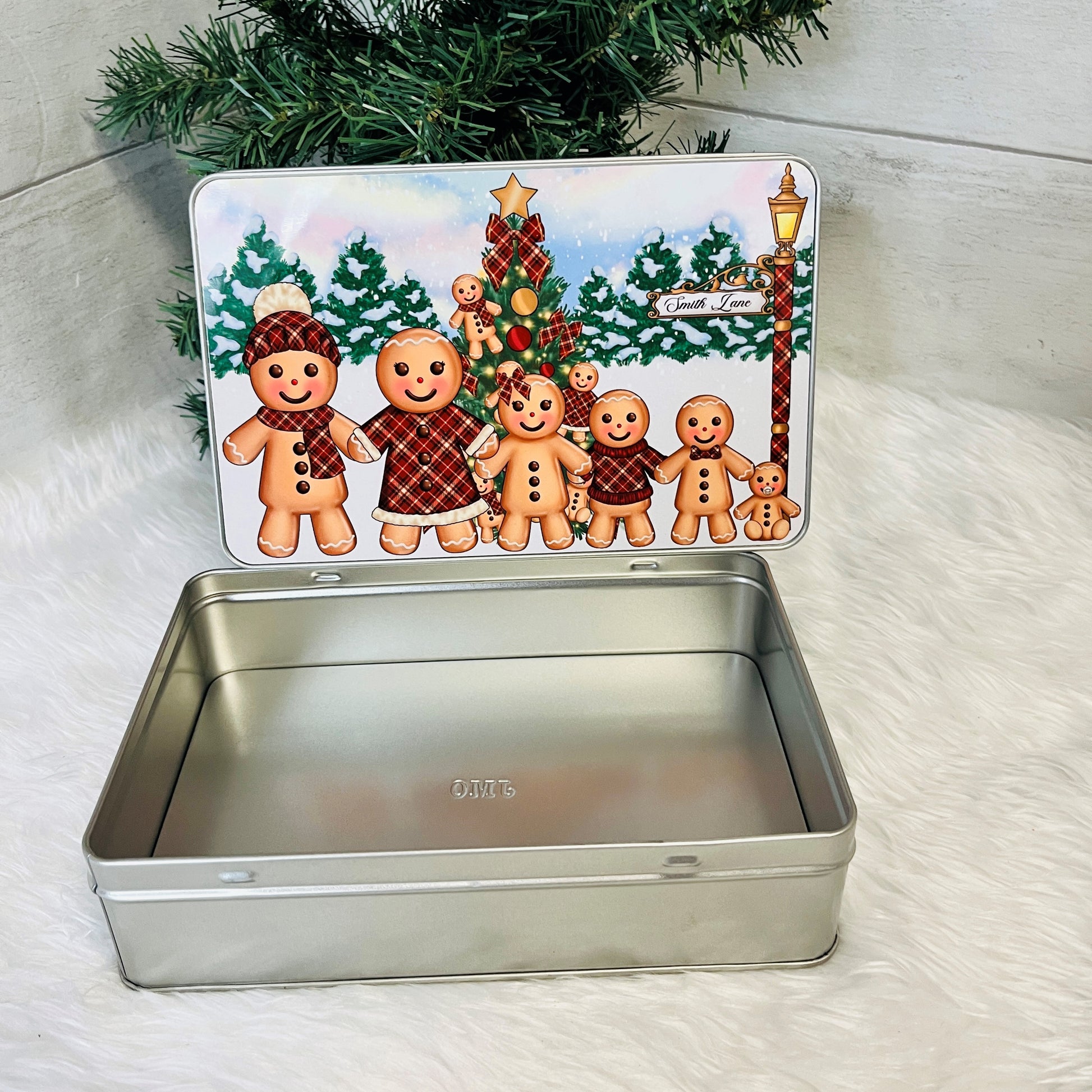 Metal tin with a Christmas-themed lid featuring gingerbread men and a tree.