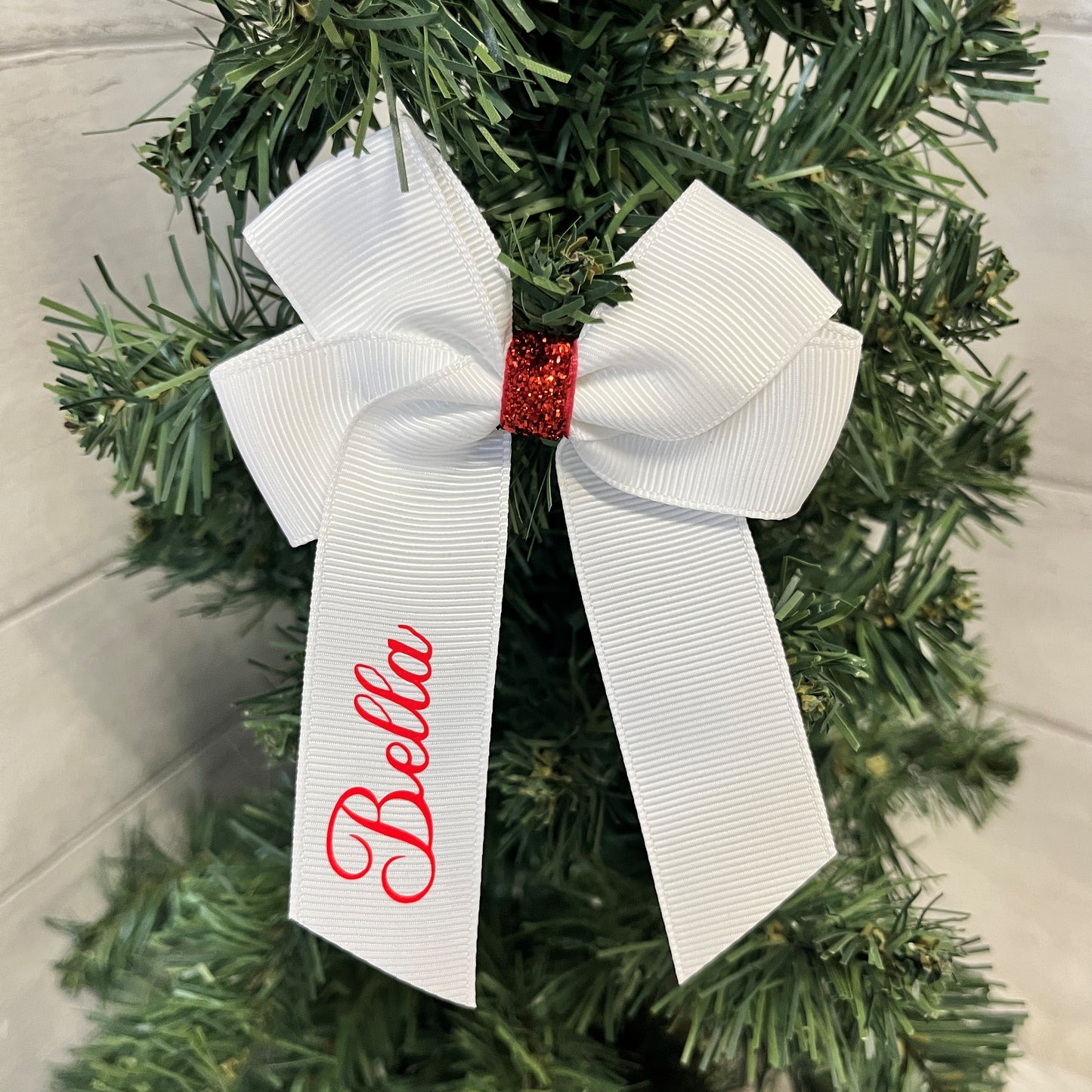 White Hair Bow made from white Grosgrain ribbon, with a red glitter clasp and a personalised name in red vinyl