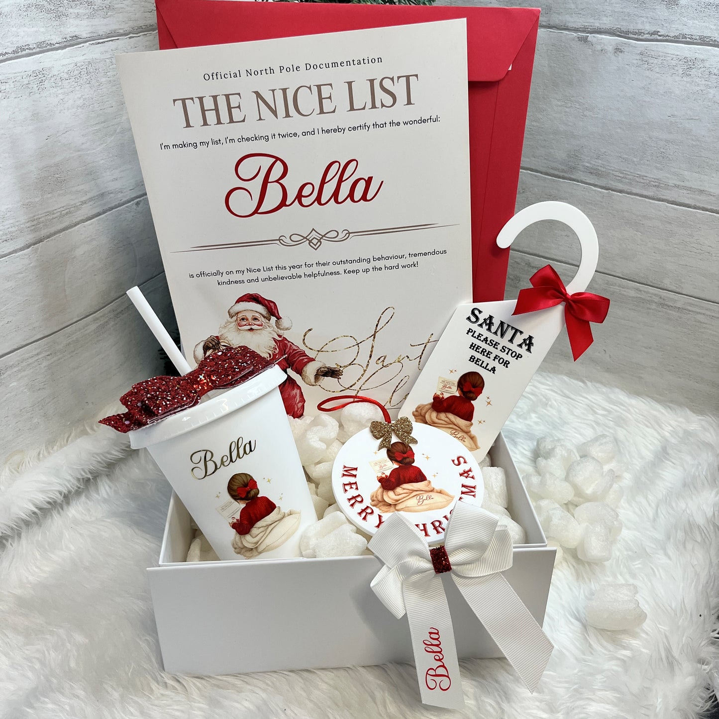 Collection of Christmas-themed items including a cup, Door Hanger, Christmas Bauble and Nice List Certificate in a Hamper Gift Box