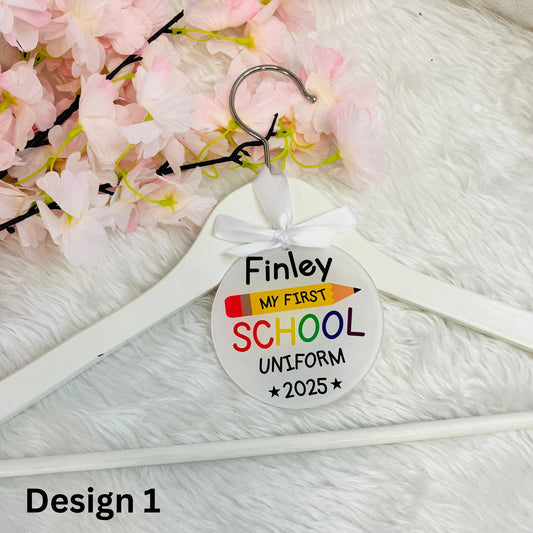 Round Hanger Tag with first day at school design on a white wooden hanger