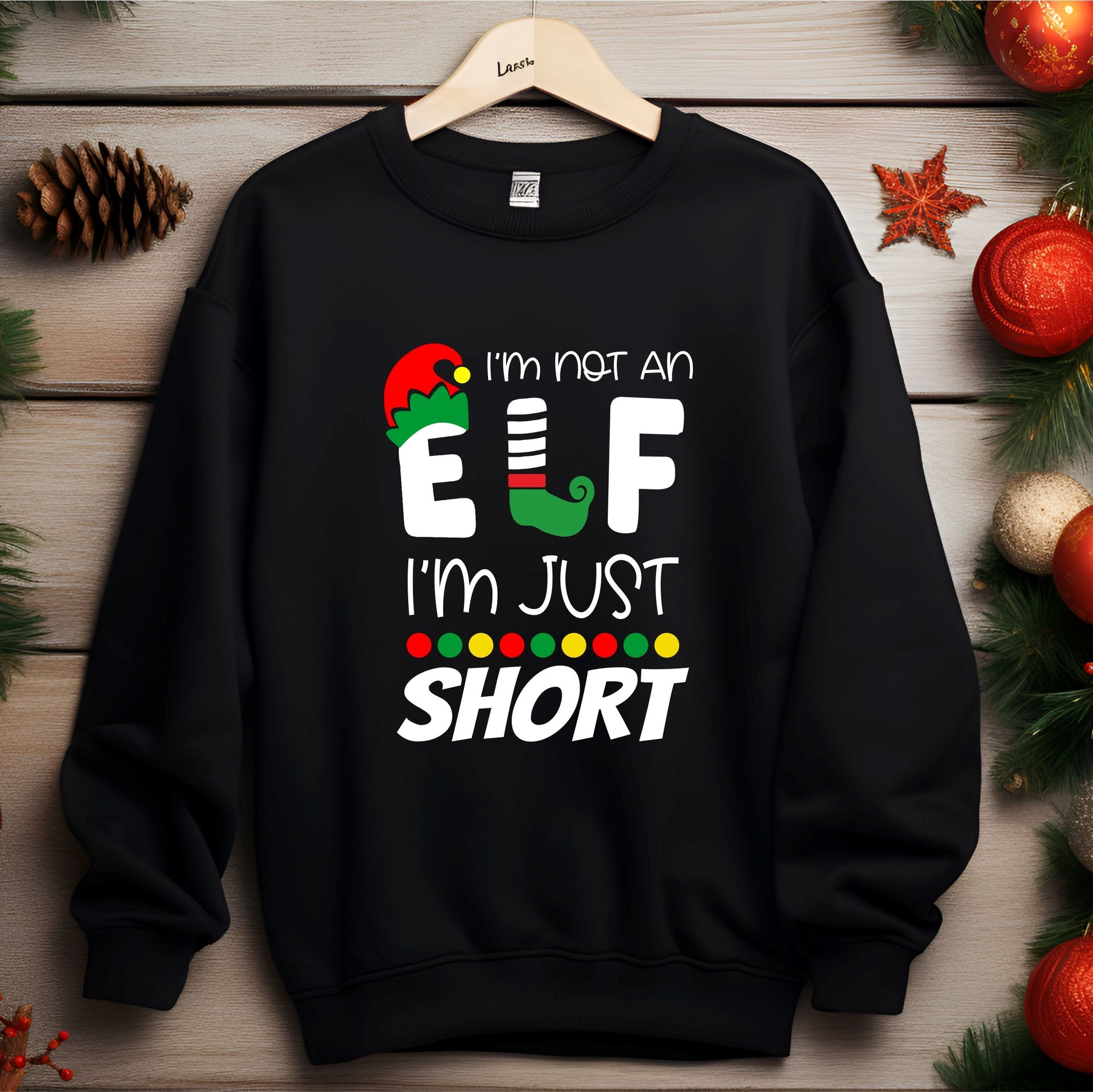 Black Jumper on a hanger with the graphic 'I'm not an elf I'm just short' on the front