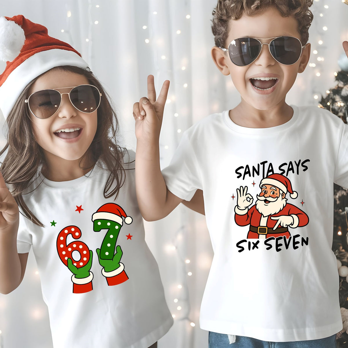 Two children wearing white graphic t-shirts with Christmas designs, posing in front of a festive background with string lights and a Christmas tree. The girl's shirt has a red and green '67' design, and the boy's shirt has a Santa Claus graphic with the text 'SANTA SAYS SIX SEVEN'.