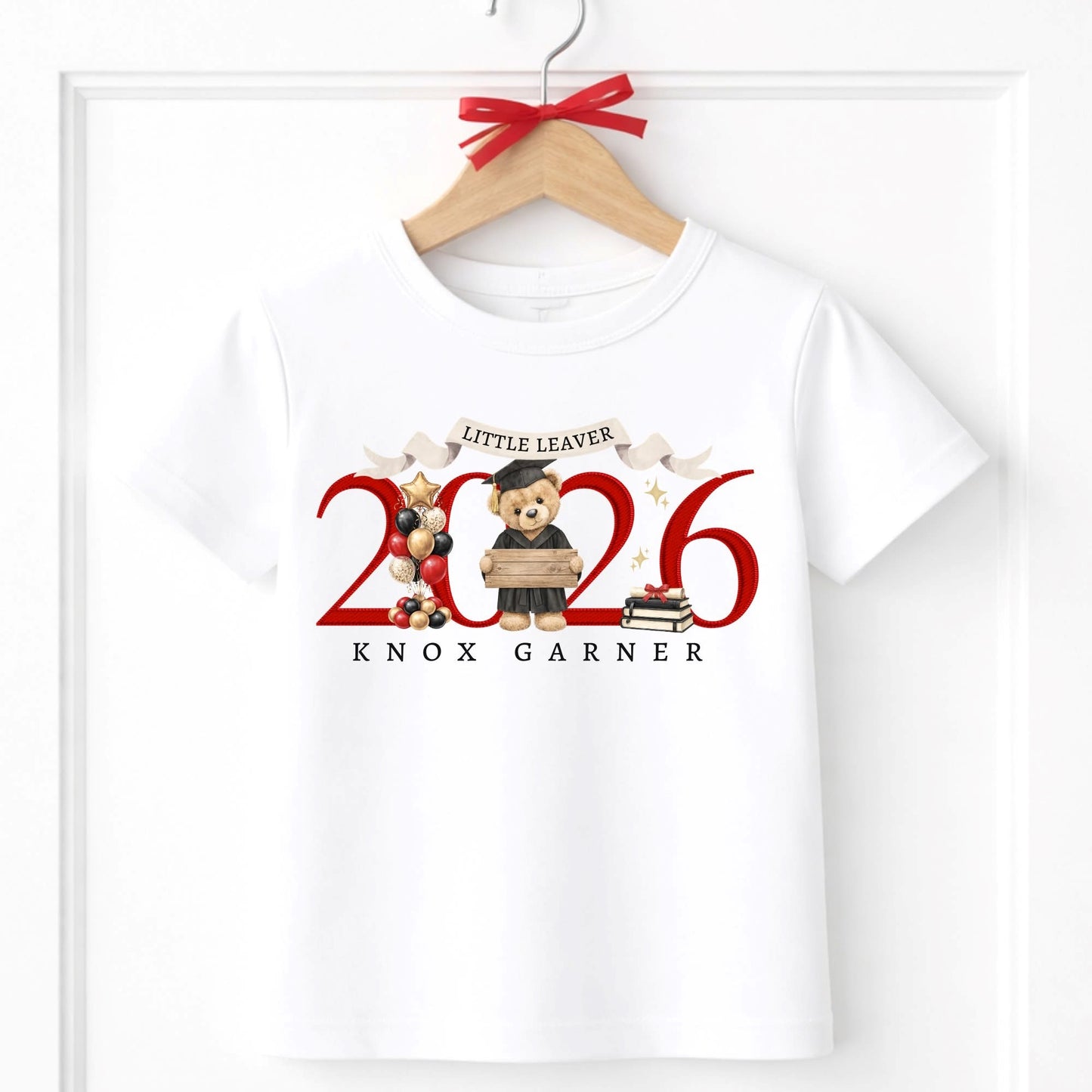 White t-shirt with 'Little Leaver 2026' design featuring bears and text, on a hanger.